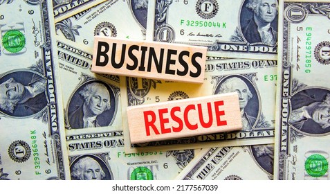 Business Rescue Symbol. Concept Words Business Rescue On Wooden Blocks On A Beautiful Background From Dollar Bills. Business Rescue And Support Concept. Copy Space.