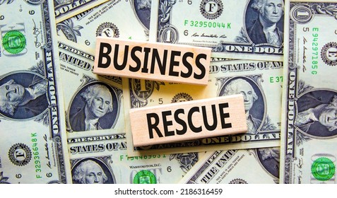 Business Rescue Symbol. Concept Words Business Rescue On Wooden Blocks On A Beautiful Background From Dollar Bills. Business Rescue And Support Concept. Copy Space.