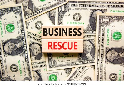 Business Rescue Symbol. Concept Words Business Rescue On Wooden Blocks On A Beautiful Background From Dollar Bills. Business Rescue And Support Concept. Copy Space.