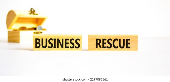 Business Rescue Symbol. Concept Words Business Rescue On Wooden Blocks On A Beautiful White Table White Background. Wooden Chest With Coins. Business Rescue And Support Concept. Copy Space.