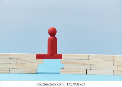 Business risk. Danger and chance. Mockup style for design. Copy space. Red wooden figures stands on plank of bridge gap - Powered by Shutterstock