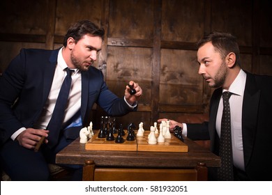 Business rivalry or competition concept. Two businessmen playing chess demonstrating competition between their offices. Business concept.