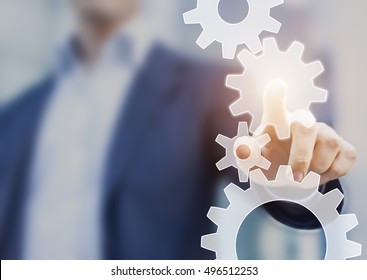 Business Robotic Process Automation And Workflow Improvement Concept Represented By A Businessman Touching A Cogwheel Connected With Other Gears