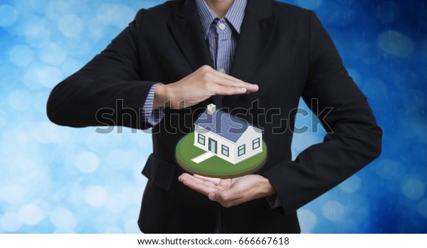business salesman hand protection home concept\
home insurance and\
mortgage.