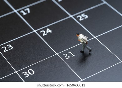 Business Schedule Plan, Travel Date Or End Of Month Pay Day For Salary Man Concept, Miniature People Businessman Figure With Suitcase Walking On 31 End Of Month Calendar.