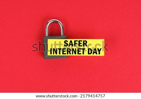 Business and security concept. On the red surface there is a lock with a sticker with the inscription - Safer Internet Day