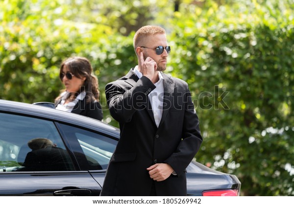 Business\
Security Guard Service At Work Near Luxury\
Car