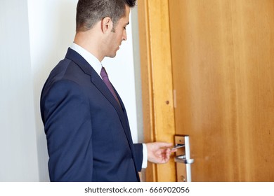 Business, Security And People Concept - Businessman With Keycard At Hotel Room Or Office Door