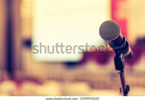 Business seminar, speech presentation, town hall\
meeting event in lecture hall or conference convention room in\
corporate or community event for host or public hearing with\
microphone voice\
speaker