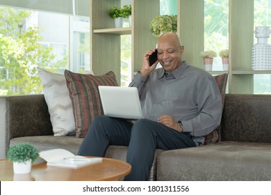 Business Senior Old Elderly Black American Man, African Person Using A Smartphone Or Mobile Phone In Living Room At Home In Technology Device Concept. Lifestyle People.