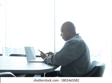 Business Senior Old Elderly Black American Man, African Person Using A Smartphone Or Mobile Phone In Living Room At Home In Technology Device Concept. Lifestyle People.