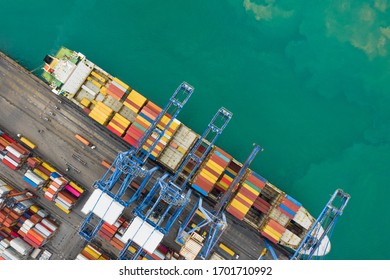  Business Service And Industry Shipping Cargo Containers Transportation Logistics By The Sea And Shipping Port Loading And Unloading By Crane And Trailer Aerial Top View From Drone Camera 