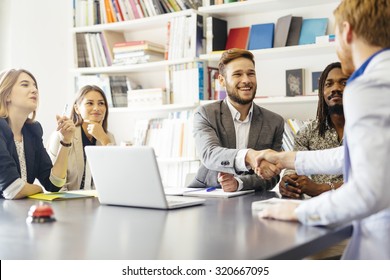 Business shaking hand with a client in office