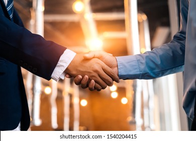 Business shaking hands, finishing up meeting. Successful businessmen handshaking after good deal. - Powered by Shutterstock