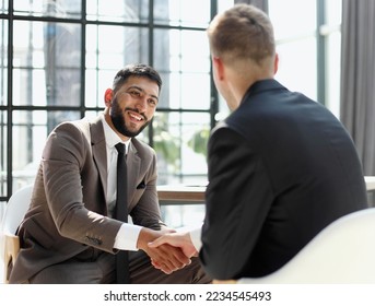 Business shaking hands, finishing up meeting. Successful businessmen handshaking after good deal. - Shutterstock ID 2234545493