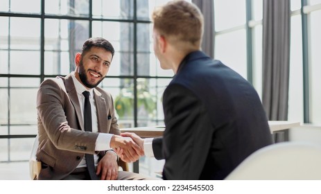 Business shaking hands, finishing up meeting. Successful businessmen handshaking after good deal. - Shutterstock ID 2234545503