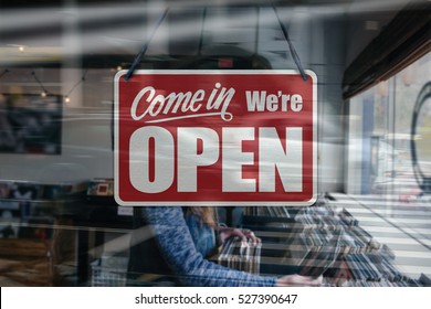 A Business Sign That Says 'Come In We're Open' On A Music/Records Store Window.