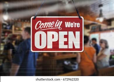 A business sign that says ‘Come in We’re Open’ on cafe/restaurant window.