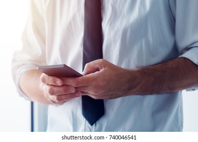 Business SMS Message. Businessman Using Mobile Phone To Send Bulk Text Messages To A Whole Business Team.