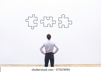 Business Solution Concept, Businessman Looking At The Pieces Of Puzzle