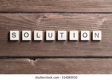 Business solution word collected of elements of wooden elements with the letters