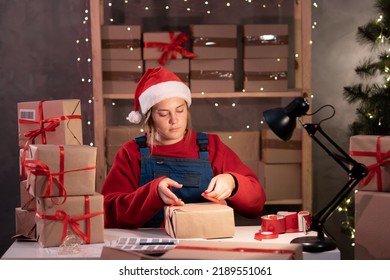 Business Start Up SME Concept. Female Startup Entrepreneur Small Business Owner Working At Home At Night, Packaging And Delivery Situation. Christmas Sale Season.