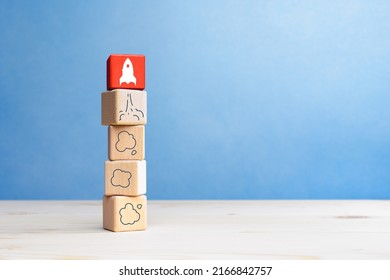 Business start up, Development and Innovation product. Wooden blocks with rocket launch icon
