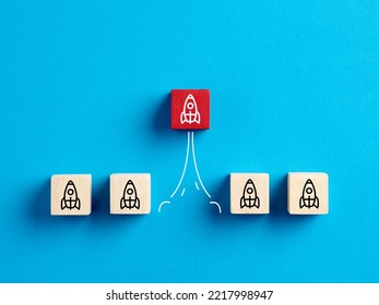 Business Start Up, Development, Innovation, Product Launch And Leadership Concepts. Rocket Icons On Wooden Blocks With One Launched Rocket.