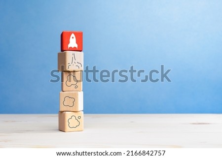 Business start up, Development and Innovation product. Wooden blocks with rocket launch icon
