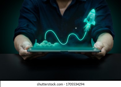 business startup concept, startup idea on tablet, a little rock lunching to the space, a man using tablet showing digital idea