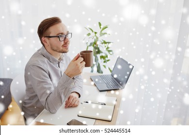 business, startup, inspiration and people concept - happy businessman or creative male worker with notebook or diary drinking coffee and thinking at home office over snow