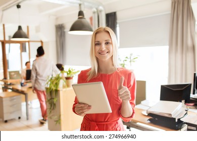 business, startup and people concept - happy businesswoman or creative female office worker with tablet pc computer showing thumbs up