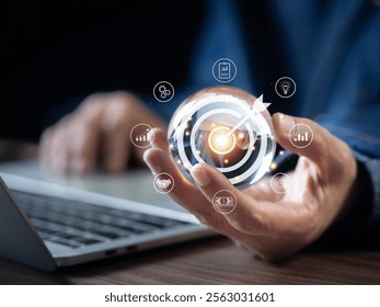 Business startup and target concept. Businessman holding a clear glass ball with icon business and network connection on modern virtual interface. Target and success and business goals.
 - Powered by Shutterstock