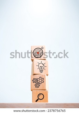 Business strategy and action plan icon on four wooden cube blocks stack isolated on white background, vertical style. Objective, goal and success, marketing and management process, startup concepts. 