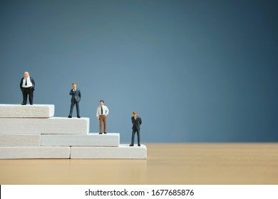 Business strategy conceptual photo - Miniature of businessman stands on a podium - Shutterstock ID 1677685876