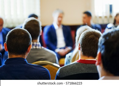 Business Style Dressed CEO Lead The Team Building Meeting In Small Class Room. Education, Business Entrepreneurship Concept. Business Conference And Presentation. Selective Focus At Rear View Student.