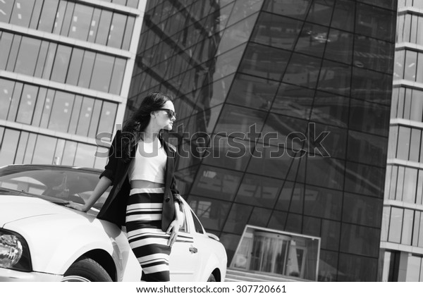 Business stylish woman near sport car black and\
white shot