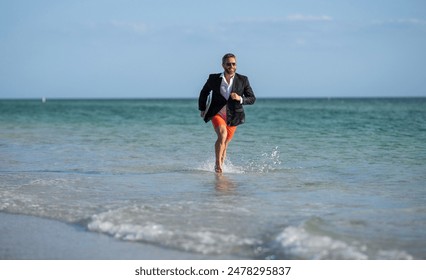 business success of businessman. Businessman in suit with laptop running in sea. successful businessman in wet suit at beach. businessman running at summer vacation. Beachside activities - Powered by Shutterstock