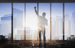 Business, Success, Gesture And People Concept - Silhouette Of Happy Businessman Raising Fist And Celebrating Victory Over Double Exposure Office And City Background