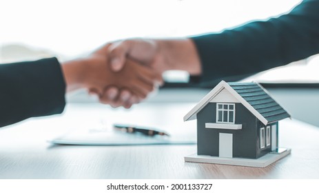 Business success, Real estate agents and customers shake hands to congratulate after signing a contract to buy a house with land and insurance, handshake and Good response concept. - Shutterstock ID 2001133727