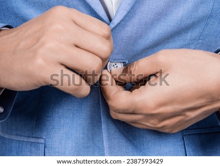 Business suit concept. Menswear for man wearing jacket. Man in suit jacket unbutton with hands. Business casual style of man, closeup. Male menswear for man in formalwear. Getting dressed [[stock_photo]] © 