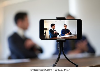 Business talk A businessman shooting a video - Powered by Shutterstock