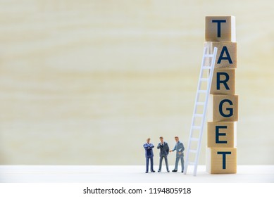 Business Target Market And Company Sales Performance Target Concept : Miniature Figurine Top Executive Management Team E.g CEO, CFO, CMO Discuss / Have A Dialog On A Firm / Corporate Financial Target.