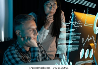 Business Team Analyzing Data On Transparent Screen. Collaborative Work, Data Analysis, Technology Insight, Digital Transformation, Innovation. Engaged Professionals, Modern Office Environment. - Powered by Shutterstock