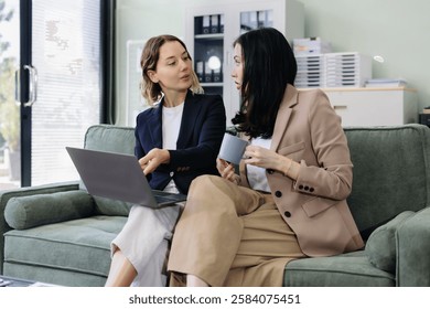 Business team analyzing documents, graphs, and data with a laptop, tablet, and smartphone. Collaboration, strategy, and success in a modern office.