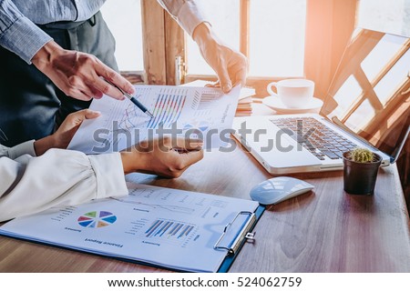 Business team analyzing income charts and graphs with modern laptop computer. Close up.Business analysis and strategy concept.