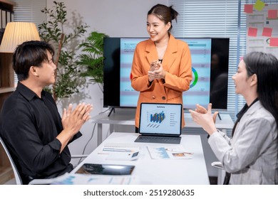 Business team applauding a speaker after a successful presentation in the office conference room - Powered by Shutterstock