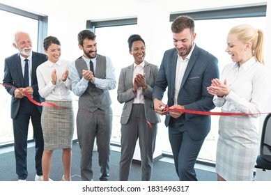 Business team applauds on cutting of red ribbon and grand opening - Shutterstock ID 1831496317
