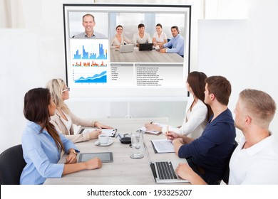 Business Team Attending Video Conference At Desk In Office