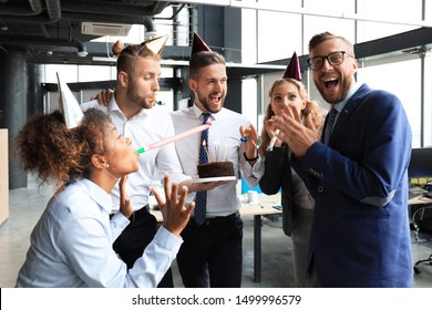 Business team celebrating a birthday of collegue in the modern office - Shutterstock ID 1499996579